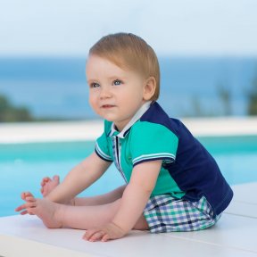 Tutto Piccolo short sleeved two-piece set combining two fabrics. Cute checked shorts with matching polo shirt.