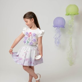 Caramelo Kids,  white top, short sleeves, shoulder frills, a mermaid print,  tulle flowers, pearls, diamanté detail, lilac skirt, shell design, glittery silver elasticated waist,  tulle lining. 012284  